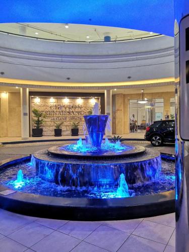 a large blue fountain in front of a building at Bellagio@Chevron, Luxe, 2 Bedroom Apartment in the Heart of Surfers Paradise! in Gold Coast
