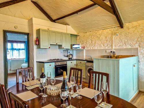 a kitchen with a table with wine glasses on it at Clyne Farm Centre in The Mumbles