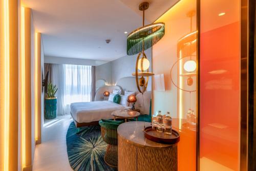 a hotel room with a bed and a table at Gem Forest Hotel Nairobi - MGallery Collection in Nairobi