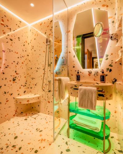 a bathroom with a rock climbing wall at Gem Forest Hotel Nairobi - MGallery Collection in Nairobi