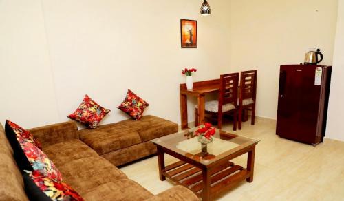 a living room with a couch and a table at Yogvan Luxury 1BHK Apartments Tapovan Rishikesh in Rishīkesh