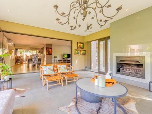 a living room with a fireplace and a table at 4onJuweel in Four Ways
