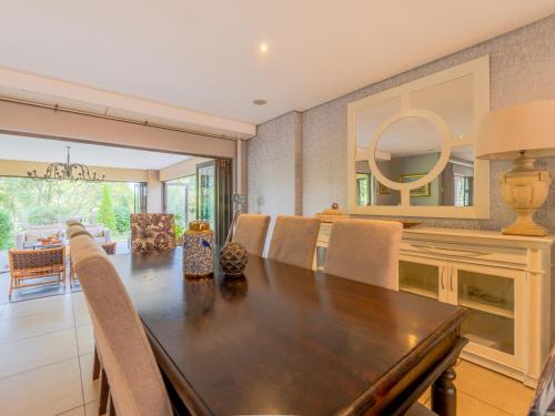 a dining room with a large wooden table and chairs at 4onJuweel in Four Ways