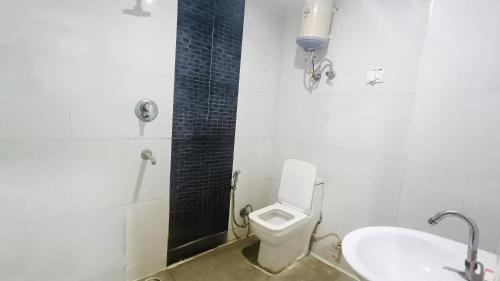 a bathroom with a toilet and a sink at Hotel Maharaja Inn - Lajpat Nagar I in New Delhi
