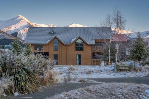 a large wooden house with snow on the ground at Royale on Cheese in Castle Hill