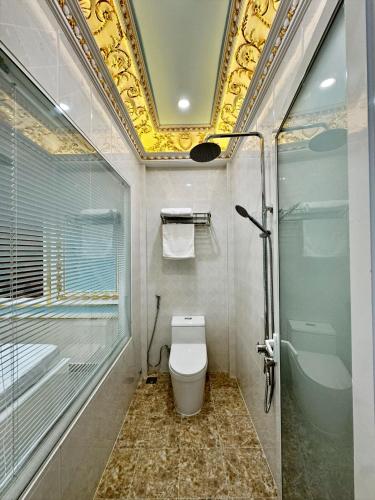 a bathroom with a toilet and a glass shower at Khách Sạn Đức Toàn in Ấp Nhì (1)