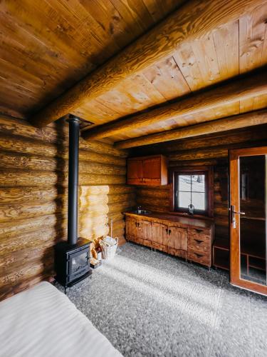 a room with a fireplace in a log cabin at Chata LESNÍ - "Lesni Udoli" in Horní Halže