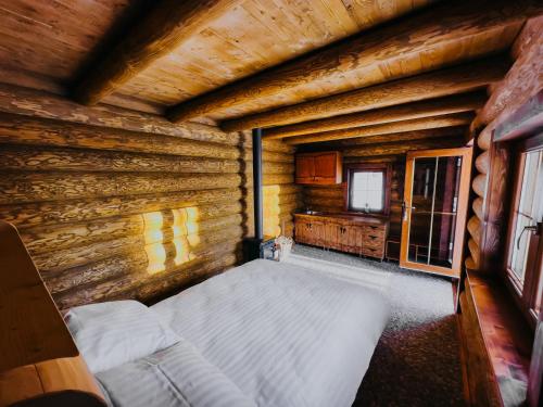 a bedroom with a bed in a log cabin at Chata LESNÍ - "Lesni Udoli" in Horní Halže