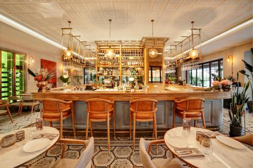 a bar in a restaurant with tables and chairs at 39 Kalamış Marina Hotel & Restaurant in Istanbul