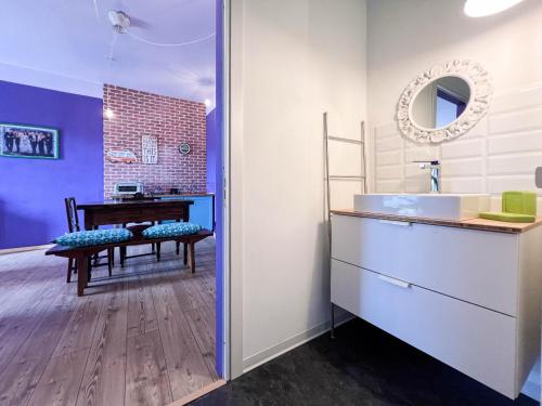 a bathroom with a sink and a table in a room at The One With The Perfect Stay in Grignasco