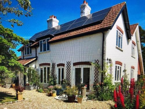 a large white house with a roof at Ramblers, Burley, New Forest in Burley