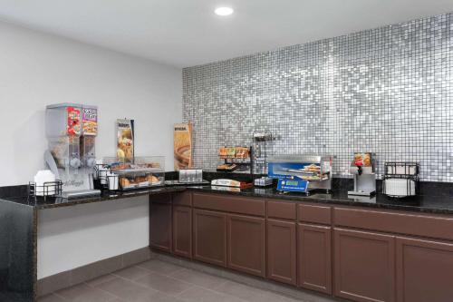 a kitchen with a counter with food on it at Microtel Inn by Wyndham Janesville in Janesville