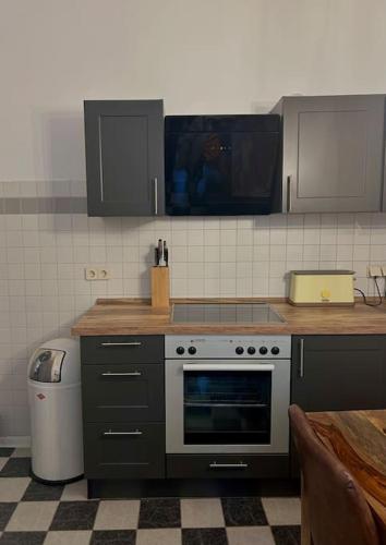 a kitchen with a stove and a counter top at Haus Violla in Ludwigsfelde