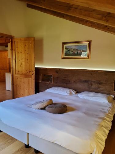 a bedroom with a large bed with two pillows on it at La Vigne de Papagran in Aosta