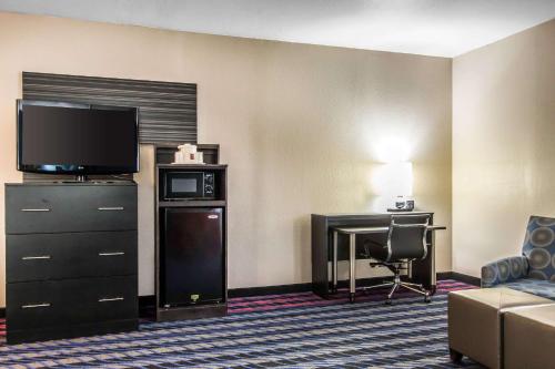 a hotel room with a television and a desk at Comfort Suites Fairgrounds West in Oklahoma City