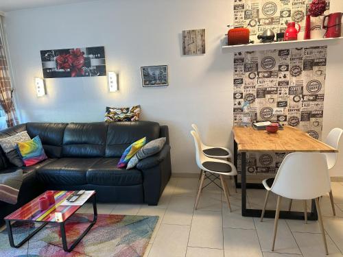 a living room with a couch and a table at Moderne und komfortable Appartements im Ferienpark Hahnenklee in Hahnenklee-Bockswiese