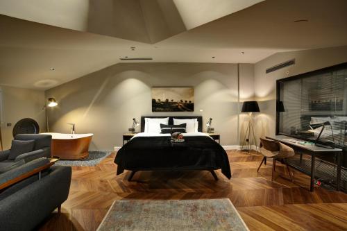 a bedroom with a bed and a living room at 39 Kalamış Marina Hotel & Restaurant in Istanbul