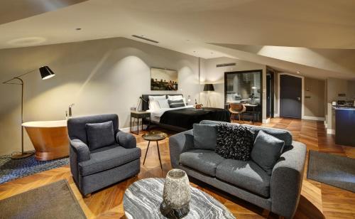 a living room with a couch and a bed at 39 Kalamış Marina Hotel & Restaurant in Istanbul