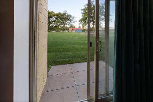 an open door with a view of a yard at Baymont by Wyndham Bay City in Bay City