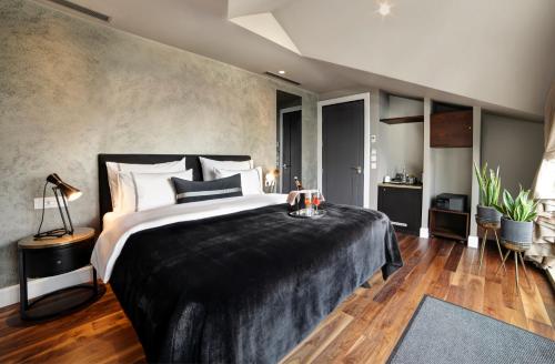 a bedroom with a large bed with a black blanket at 39 Kalamış Marina Hotel & Restaurant in Istanbul