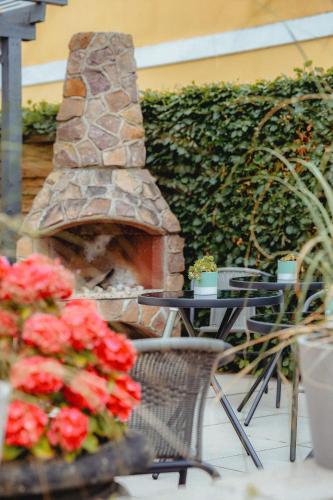 a stone fireplace sitting next to a table and flowers at Strandidyl Bed and Breakfast in Haderslev