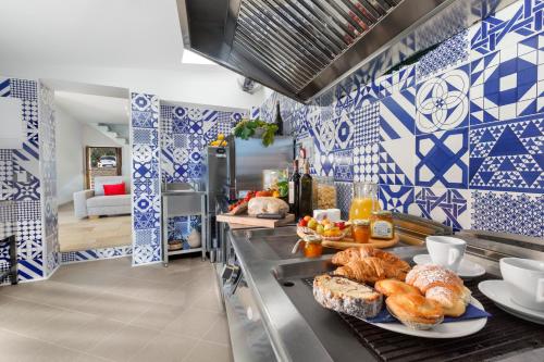 a kitchen with blue and white tiles on the wall at VillaCrapolla Sorrento in Massa Lubrense
