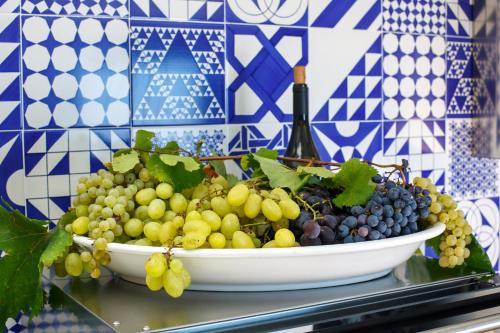 a bowl of grapes sitting on a table at VillaCrapolla Sorrento in Massa Lubrense