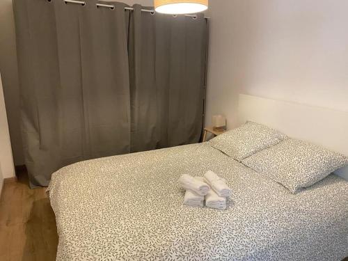 une chambre avec un lit avec deux serviettes dessus dans l'établissement Appartement cosy au cœur de Metz, à Metz
