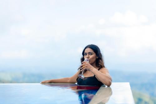 a woman in the water smoking a pipe at Le Montfort Resort in Munnar