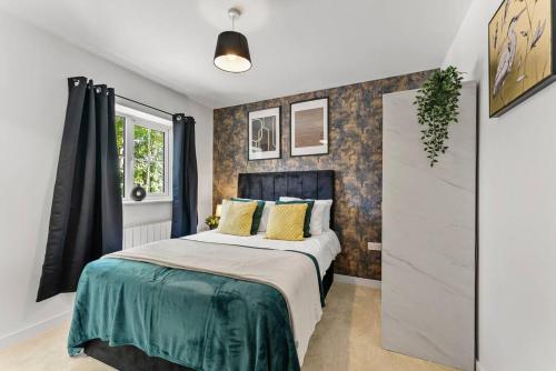 a bedroom with a large bed with yellow pillows at Large and Stylish Abode in Nottingham - Sleeps 15 in Nottingham
