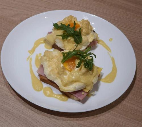a white plate of food with an egg on it at Sport Hotel 2 in Cherkasy