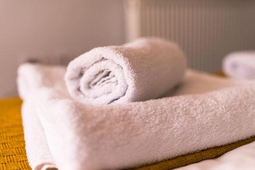 a roll of white towels sitting on a table at The Sunset Apartment - Margate Beach - By Goldex Coastal Breaks in Margate