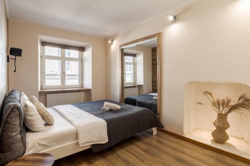 a bedroom with a bed and a large mirror at TUT Staroevreyska С Apartment in Lviv