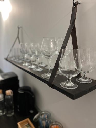 a row of wine glasses sitting on a shelf at Hof van Balloo in Balloo