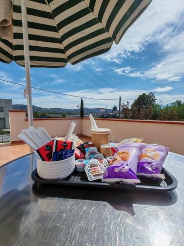 a tray of food on a table under an umbrella at B&B Villa Angela Via della bonifica 17 in Villareia
