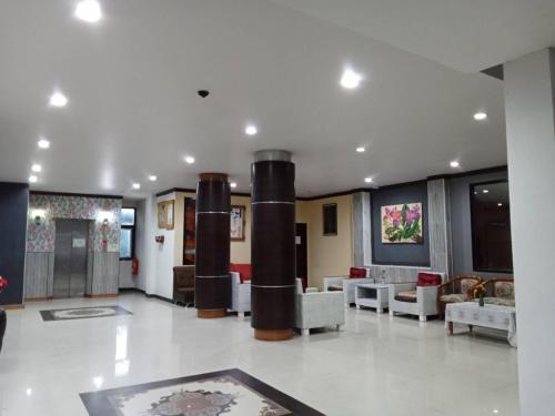 a large lobby with couches and tables in a building at PS Hotel Saraburi in Sara Buri