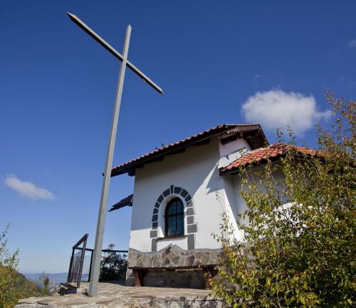 a church with a windmill in front of it at Family Hotel Teteven in Teteven