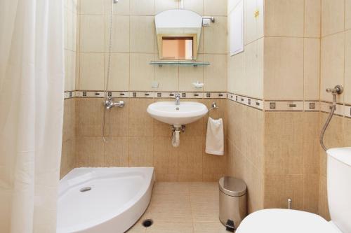 a bathroom with a sink and a toilet at Apart Hotel Vechna R in Sunny Beach