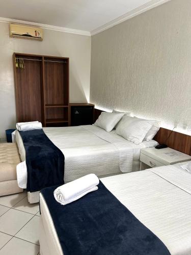 a hotel room with two beds with towels on them at Nautillus Hotel in Parnaíba