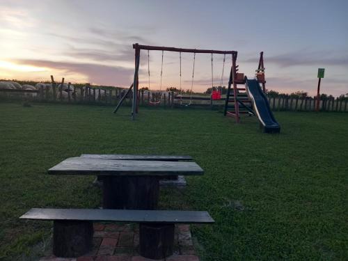 a park with a picnic table and swings at Resort Dudukovic 1 in Slunj