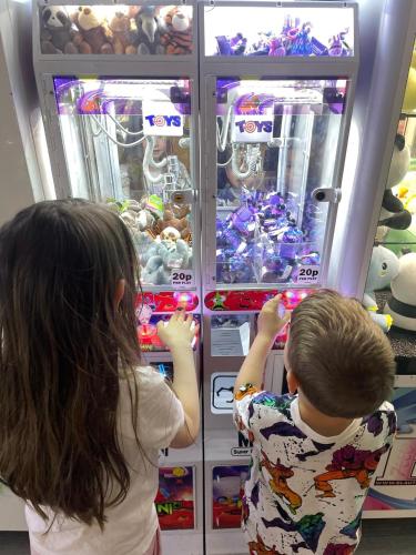 two young children looking into an open refrigerator at Hiba Luxury Lodge At Parkdean Cayton Bay Holiday Park in Scarborough