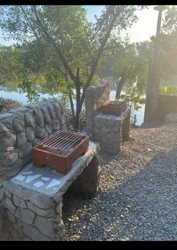 two suitcases sitting on a stone bench in a park at Igid Puttot Guest Cabins in Bangcusay