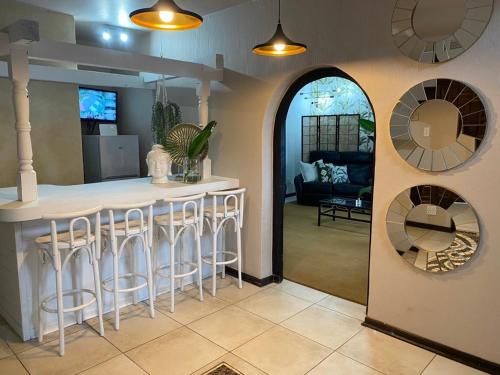 a kitchen with a counter and a bar with stools at Zinkwazi Beach House in Zinkwazi Beach