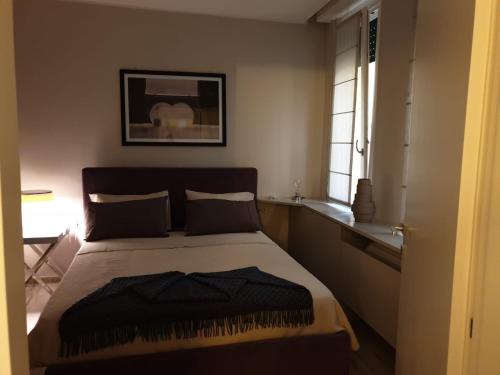 a bedroom with a bed with a black blanket on it at Casa delle Farfalle in Bologna