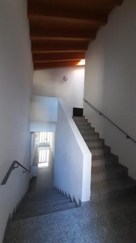 a staircase in a building with a stair case at Loft Tirano centro storico - open space Adele in Tirano
