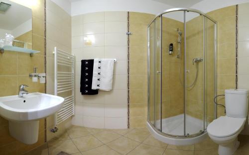a bathroom with a shower and a toilet and a sink at Luxury Apartment Krištof in Bešeňová