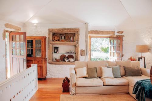 a living room with a couch and a window at Just Like Home - Casa do Cadinho in Viana do Castelo