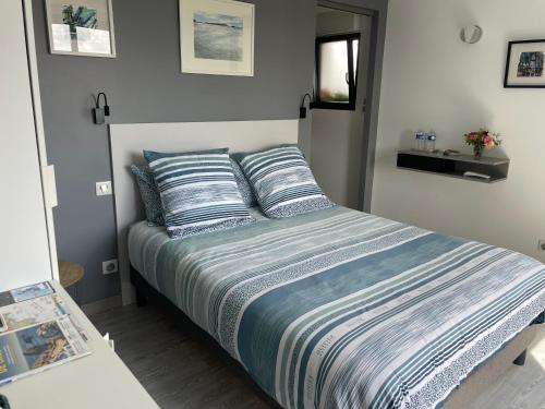 a bedroom with a bed with two pillows on it at Chez Lorenz in Hôpital-Camfrout