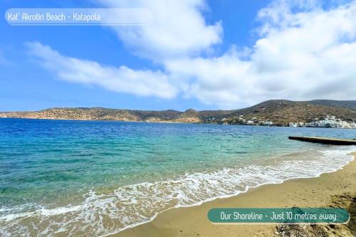 a view of the beach with mountains in the background at Eleni On The Beach in Katapola
