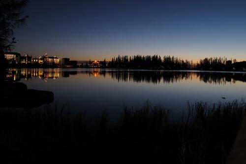 a view of a large lake at night at Apartmán Štrbské Pleso - Crocus 219 in Vysoke Tatry - Strbske Pleso